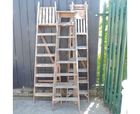 A vintage wooden step ladder, together with two others, tallest 200cm