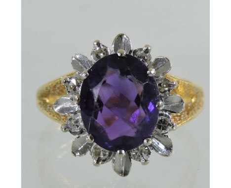 An 18 carat gold, amethyst and diamond cluster ring, boxed 