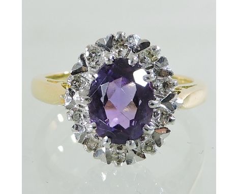 An 18 carat gold amethyst and diamond cluster ring, boxed 