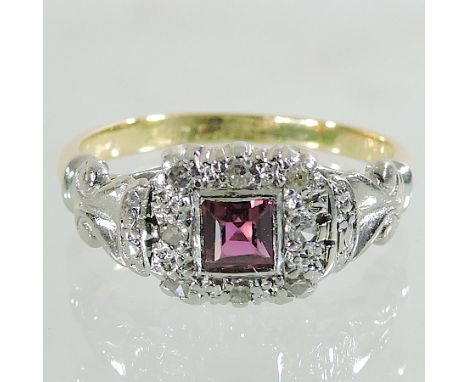 An 18 carat gold diamond and ruby ring, boxed 