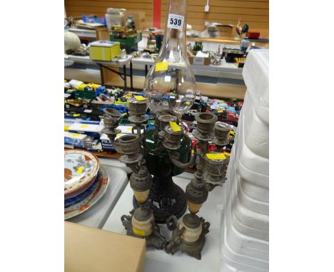 A pair of metallic candlestick holders & a vintage oil lamp