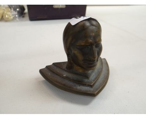 A cast metal bust of a Native American Indian (probably a finial from a gaming machine)