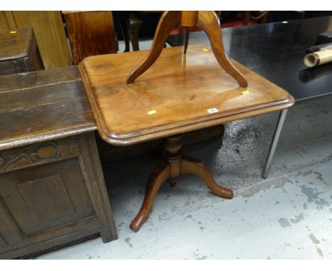 An antique Victorian mahogany tilt-top tripod table
