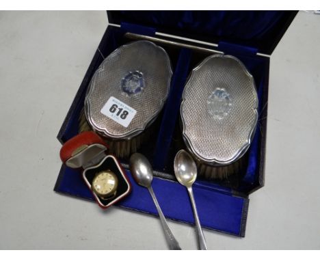 A cased set of silver backed brushes & comb together with two silver spoons & a cased watch dial