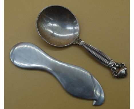 Sterling silver Georg Jenson caddy spoon together with a Georg Jenson stainless bottle opener