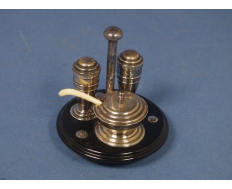 Vintage four piece condiment set including  silver plated salt shaker, pepper pot and mustard pot with spoon, all set in Bake
