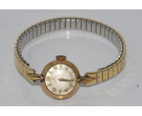 Vintage ladies 9ct gold Omega wristwatch with later band. Glass damaged.