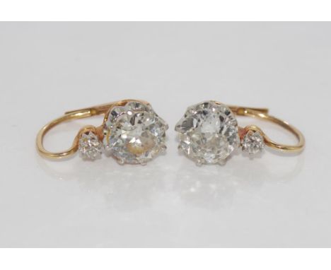 Pair of antique large diamond (1ct+ each) earrings set in 14k rose & white gold, with two early modern round brilliant cut di