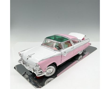 Long body model car colored in pink and white. Designed at 1/18th scale with doors, trunk and hood that open. This item comes