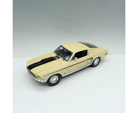 Beautiful die-cast depiction of a classic cream colored car that is accented with a racing stripe. Driver and passenger doors