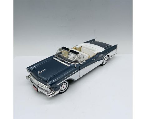 Beautiful die-cast depiction of a yale blue car with white interiors and whitewall tires as well as an etching that reads Ame