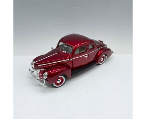 Candy red 1:18 scale model car with cream colored interiors. Moveable parts include hood, doors and trunk with includes a spa