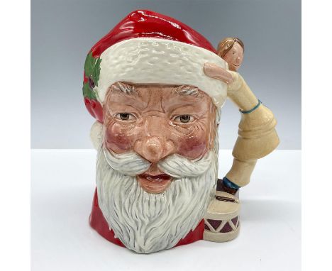 Glossy porcelain. Modeled in vibrant red, white and brown colors, with the doll and drum handle. Royal Doulton backstamp. Art