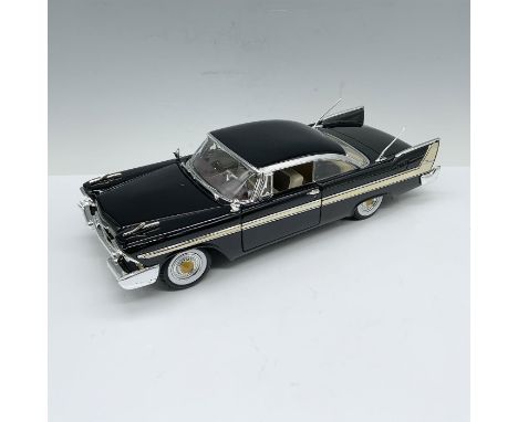 Die-cast depiction of an elegant black car that is adorned with chrome accents and whitewall tires. Driver and passenger door