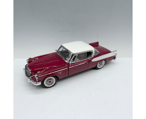 Splendid die-cast depiction of a classic plum red car that is adorned with white and chrome accents. Driver and passenger doo