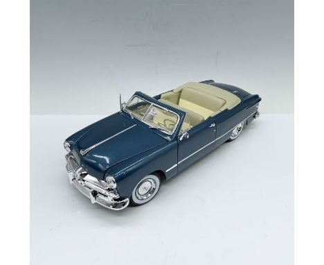 Prussian blue 1:18 scale convertible model with cream interiors and a moveable hood, trunk, and doors. Maisto impressed mark.