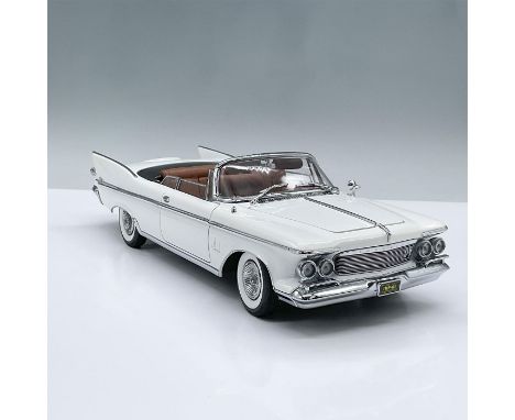 This white model car has movable parts including, two doors, the hood, the trunk, two seats and a front wheel drive mechanism