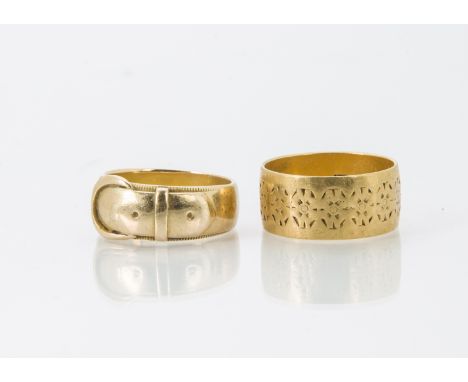 Two early 20th century 22ct gold gentlemen's wedding bands, one in the form of a belt and buckle, the other wide with engrave