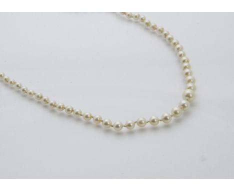 An Art Deco period pearl necklace, white freshwater cultured graduating pearls with a silver clasp, with a vintage retailers 