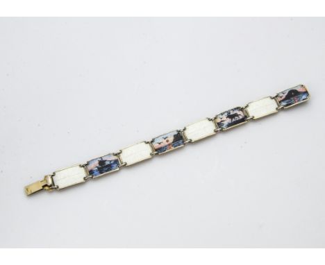 A 1960s silver and enamel bracelet, having octagonal white guilloche panels and coloured panels with landscapes, marked KS or