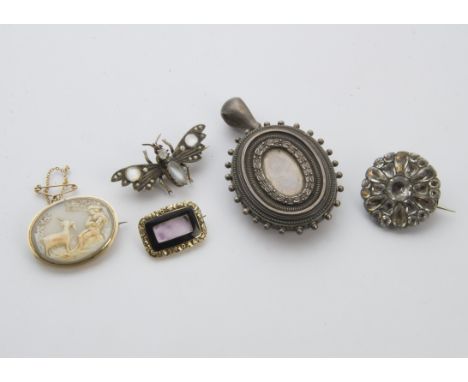 A group of four Victorian and later brooches and a pendant, including a gold and black enamel mourning brooch, a moonstone be