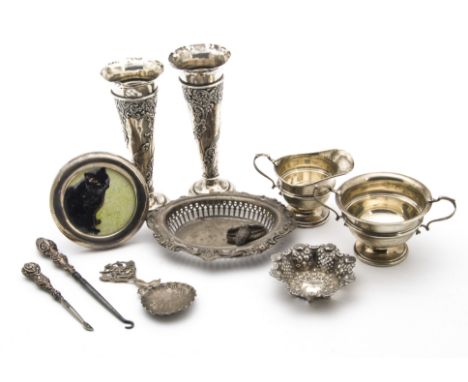 A group of Victorian and later silver items, including a pair of filled trumpet vases, a sugar basin and milk jug, embossed d