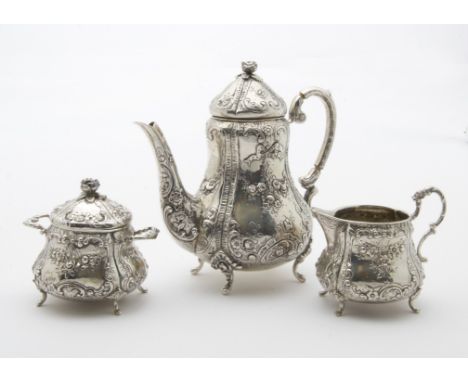 A mid to late 19th century German silver three piece bachelors tea set, rococo themed comprising teapot with hinged cover, a 