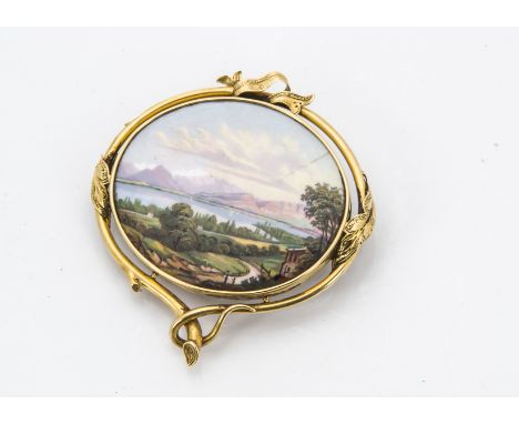 A late 19th century continental enamel brooch, the oval panel with Tirolean lake and mountain scene, cracked, in a yellow met
