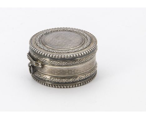 A late 19th century continental silver circular box, with engine turned and laurel design, hinge with small loop bale, 4.2cm 