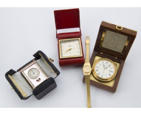 A 1980s gild quartz travel alarm clock from Asprey, in wooden case, together with a miniature carriage timepiece style travel