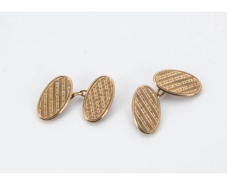 A pair of George V 9ct cufflinks, oval panels with engine turned design with chains, 7g (2) 