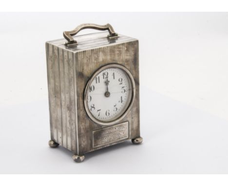 A George V silver presentation mantel clock by William Comyns, rectangular carriage timepiece case with French movement, havi