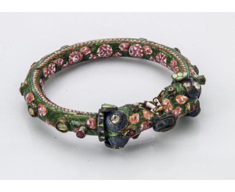 A vintage Indian enamelled bangle, in green, pink and white set with semi-precious stones, having crude hinged clasp of two e