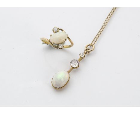 A vintage gold opal and white sapphire ring and pendant, the crossover style mount with an oval white opal and a pair of old 