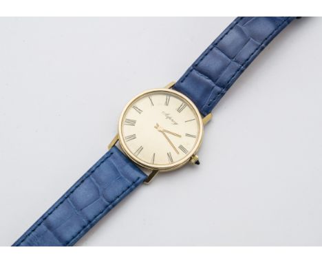 A modern 9ct gold Asprey gentleman's wristwatch, circular with baton numerals, manual wind, appears to run, on blue leather s