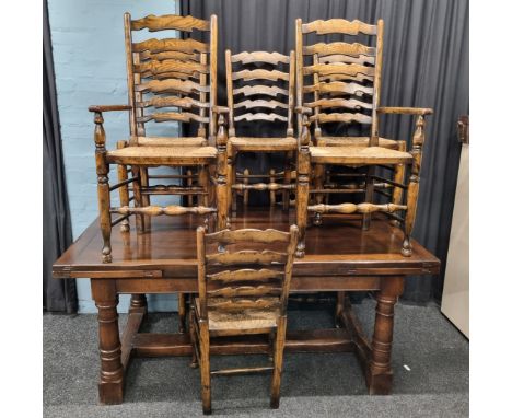 A reproduction Brights of Nettlebed style oak drawer leaf table, of rectangular form on baluster supports with stretcher unde