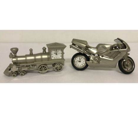 2 novelty diecast model clocks in the shape of a train and a motorcycle. Quartz movement clocks with silver coloured diecast 