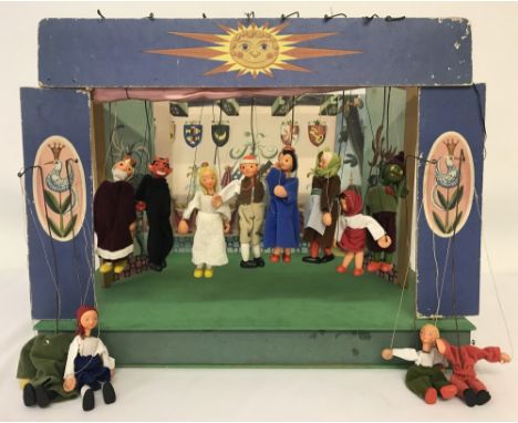 A vintage hand-made wooden puppet theatre, made in Czechoslovakia,In its own fold-up case. Complete with scenery &amp; 12 ori