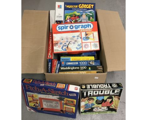 A collection of vintage toys, games and jigsaw puzzles. To include 1960's Trouble pop o matic game and a boxed Magic Screen E