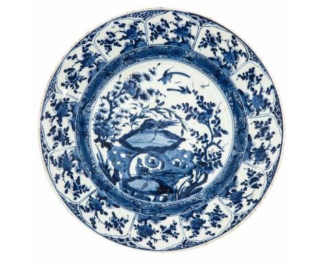 Depicting scene with rocks and birds in center of charger with flower blossoms on border, Kangxi Period, 38 cm. in diameter, 