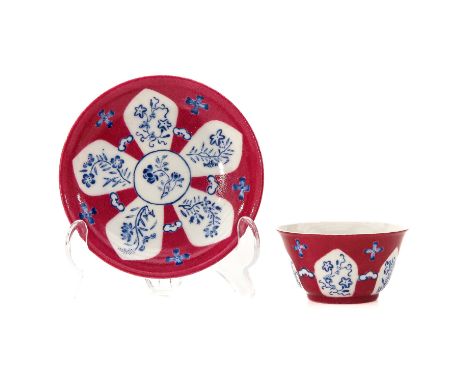 Ruby ground decorated with blue flowers, saucer is 11 cm. in diameter, 