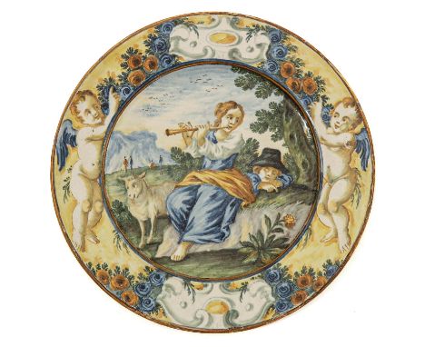 in gold/yellow hue with the image of a sleeping shepherd and a shepherdess playing a flute with a sheep Castelli 18/19th cent