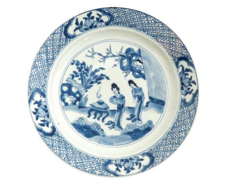 Kangxi Mark and Period, depicting Chinese ladies in garden, 21 cm. in diameter, hairline.