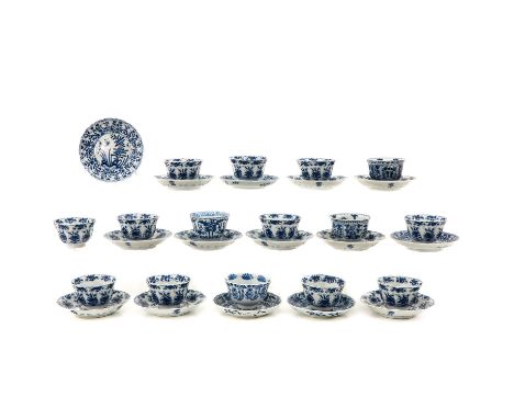Blue and white decor depicting floral borders with scene in center of saucers depicting flowers and rocks, including Kangxi 4