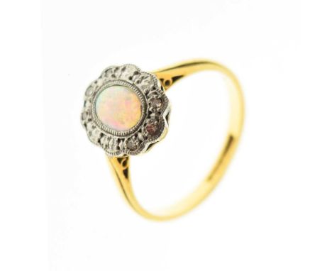 Opal and diamond cluster ring, the opal cabochon within a diamond set illusion setting, the shank stamped '18ct &amp; Plat', 