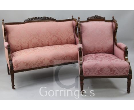 An early 20th century mahogany framed two seat sofa and matching armchair, in neo-classical style, with pink brocade upholste