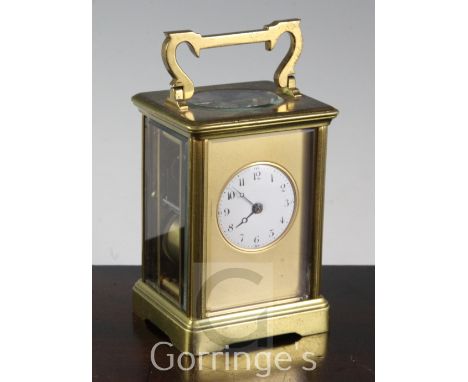 A French gilt brass carriage clock, with white enamel circular dial and gilt mask, early 20th century, 17cm