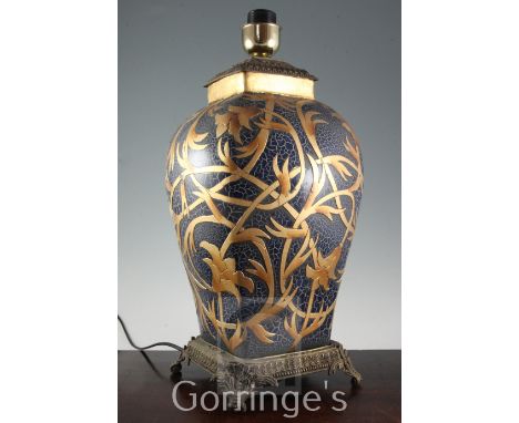 A modern ceramic and gilt metal mounted table lamp, with pleated fabric shade, 51cm high to fitting