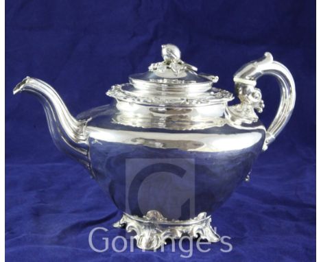 A late Victorian silver plated teapot, of inverted pear form, with scroll feet and melon finial.