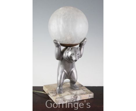 An Art Deco style spelter figural "bear" lamp, with glass globe shade and marble base, 35.5cm